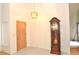 Bright foyer showcasing tile flooring, modern lighting and an antique grandfather clock at 5530 Salem Square N Dr, Palm Harbor, FL 34685