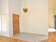 Bright foyer features stylish chandelier, tile floors, and wood front door at 5530 Salem Square N Dr, Palm Harbor, FL 34685