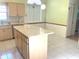 Charming kitchen features an island, stainless steel appliances, and tiled flooring at 5530 Salem Square N Dr, Palm Harbor, FL 34685