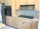 Efficient kitchen with stainless steel appliances, light cabinetry, and electric cooktop at 5530 Salem Square N Dr, Palm Harbor, FL 34685