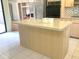 Open kitchen with island, stainless steel appliances, and ample storage at 5530 Salem Square N Dr, Palm Harbor, FL 34685