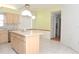 Bright kitchen with island and tiled floor at 5530 Salem Square N Dr, Palm Harbor, FL 34685