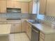 Clean kitchen with a double basin sink and stainless steel dishwasher at 5530 Salem Square N Dr, Palm Harbor, FL 34685