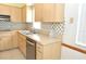 Well-lit kitchen featuring stainless steel dishwasher, double sink, and laminate countertops at 5530 Salem Square N Dr, Palm Harbor, FL 34685