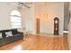 Spacious living room with tile and hardwood flooring, modern light fixture and large window at 5530 Salem Square N Dr, Palm Harbor, FL 34685