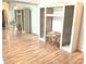 Open living room features a custom storage system with mirrored walls and hardwood floors at 5530 Salem Square N Dr, Palm Harbor, FL 34685