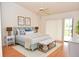 Bright main bedroom with vaulted ceilings, ceiling fan, and sliding glass doors to the backyard at 5530 Salem Square N Dr, Palm Harbor, FL 34685