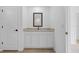 Bathroom vanity featuring light granite countertops, white cabinets, and a dark-framed mirror, adding modern flair at 5830 Babian Rd, North Port, FL 34291