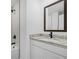 This bathroom features a sleek vanity with granite countertops, a black faucet, and a coordinated framed mirror at 5830 Babian Rd, North Port, FL 34291