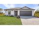 Charming single-Gathering home with a well-maintained lawn and a two-car garage at 5830 Babian Rd, North Port, FL 34291