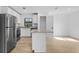 Modern kitchen features stainless appliances, granite countertops, and an island for seating at 5830 Babian Rd, North Port, FL 34291
