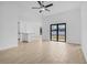 Bright living room with fan and tile flooring that blends seamlessly into adjacent rooms at 5830 Babian Rd, North Port, FL 34291