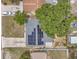 Aerial view of home featuring solar panels on the roof and a long driveway with two parked cars at 6497 43Rd N Ave, Kenneth City, FL 33709