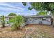 Backyard featuring an AC unit and some foliage at 6497 43Rd N Ave, Kenneth City, FL 33709