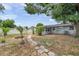 Spacious backyard features mature trees and a stone path for a tranquil outdoor space at 6497 43Rd N Ave, Kenneth City, FL 33709