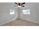 Bedroom includes ceiling fan, two large windows and carpeted flooring at 6497 43Rd N Ave, Kenneth City, FL 33709