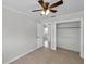 Neutral bedroom offers carpeted floor, ceiling fan, and walk-in closet at 6497 43Rd N Ave, Kenneth City, FL 33709