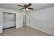 Bedroom view with carpet, ceiling fan, closet, and access to the bathroom at 6497 43Rd N Ave, Kenneth City, FL 33709