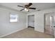Bedroom featuring ceiling fan, closet, and window with a view to the outside at 6497 43Rd N Ave, Kenneth City, FL 33709