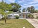 Charming single-story home featuring solar panels, awning-covered windows, and a convenient covered carport at 6497 43Rd N Ave, Kenneth City, FL 33709