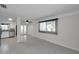 Open floor plan with tile flooring and a kitchen view, illuminated by natural light from a window at 6497 43Rd N Ave, Kenneth City, FL 33709