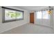 Living room featuring tile floors and a large window with privacy blinds, offering natural light at 6497 43Rd N Ave, Kenneth City, FL 33709