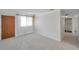Living room featuring tile floors, a large window, and a door leading to the hallway at 6497 43Rd N Ave, Kenneth City, FL 33709