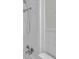 A detailed shot of the updated shower head and faucet within the tiled shower stall at 6497 43Rd N Ave, Kenneth City, FL 33709