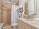 Bathroom showcasing a neutral decor, a shower with a curtain, and a vanity with storage at 6706 S Trask St, Tampa, FL 33616