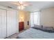 Cozy bedroom featuring a comfortable bed, closet, dresser, and soft natural light through a window at 6706 S Trask St, Tampa, FL 33616