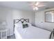 Bright bedroom with a queen bed, ceiling fan, and decorative mirror, creating a cozy and inviting space at 6706 S Trask St, Tampa, FL 33616