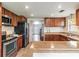 Spacious kitchen with wood cabinets, updated appliances, and a breakfast bar at 6706 S Trask St, Tampa, FL 33616