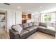 Inviting living room featuring stylish wood-look tile flooring and a comfortable sectional sofa at 6706 S Trask St, Tampa, FL 33616