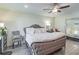 Comfortable main bedroom with a ceiling fan, light hardwood floors, and stylish furnishings at 6706 S Trask St, Tampa, FL 33616