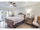 Comfortable main bedroom with a ceiling fan, light hardwood floors, and stylish furnishings at 6706 S Trask St, Tampa, FL 33616