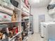 Organized storage area with shelving units, laundry machines, and ample space for household items at 6706 S Trask St, Tampa, FL 33616