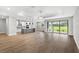Spacious living room featuring hardwood floors, modern ceiling, and sliding glass doors at 6757 Summit View Dr, Brooksville, FL 34601