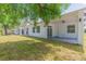 Home backyard featuring covered patio and lush green lawn at 723 W 113Th Ave, Tampa, FL 33612