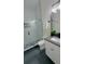 Bathroom walk-in shower featuring sleek white subway tile and bold geometric accents at 723 W 113Th Ave, Tampa, FL 33612