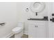 Stylish powder room features a vessel sink, modern fixtures, and a round decorative mirror at 723 W 113Th Ave, Tampa, FL 33612