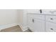 Bathroom featuring white cabinets with black and gold hardware and a marble countertop at 723 W 113Th Ave, Tampa, FL 33612