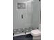 Bathroom walk-in shower featuring a modern design with sleek white subway tile and bold geometric accents at 723 W 113Th Ave, Tampa, FL 33612