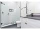 Bathroom features a glass-enclosed shower, patterned tile, and vanity with gray countertop at 723 W 113Th Ave, Tampa, FL 33612