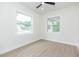 Bright bedroom with large windows, light wood flooring, and neutral walls at 723 W 113Th Ave, Tampa, FL 33612