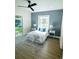 Bright bedroom with a sliding door, a ceiling fan, and stylish lamps at 723 W 113Th Ave, Tampa, FL 33612