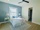 Bright bedroom featuring a large window, stylish lamps, and a cozy bed at 723 W 113Th Ave, Tampa, FL 33612