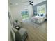 Bright bedroom with a sliding door, a ceiling fan, and stylish lamps at 723 W 113Th Ave, Tampa, FL 33612