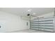 Spacious garage with an automatic door and white door leading to inside at 723 W 113Th Ave, Tampa, FL 33612