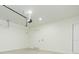 View of garage with white door to inside, concrete floor, and garage door opener at 723 W 113Th Ave, Tampa, FL 33612