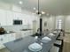 Bright kitchen with a large center island, modern lighting, and stainless steel microwave at 723 W 113Th Ave, Tampa, FL 33612